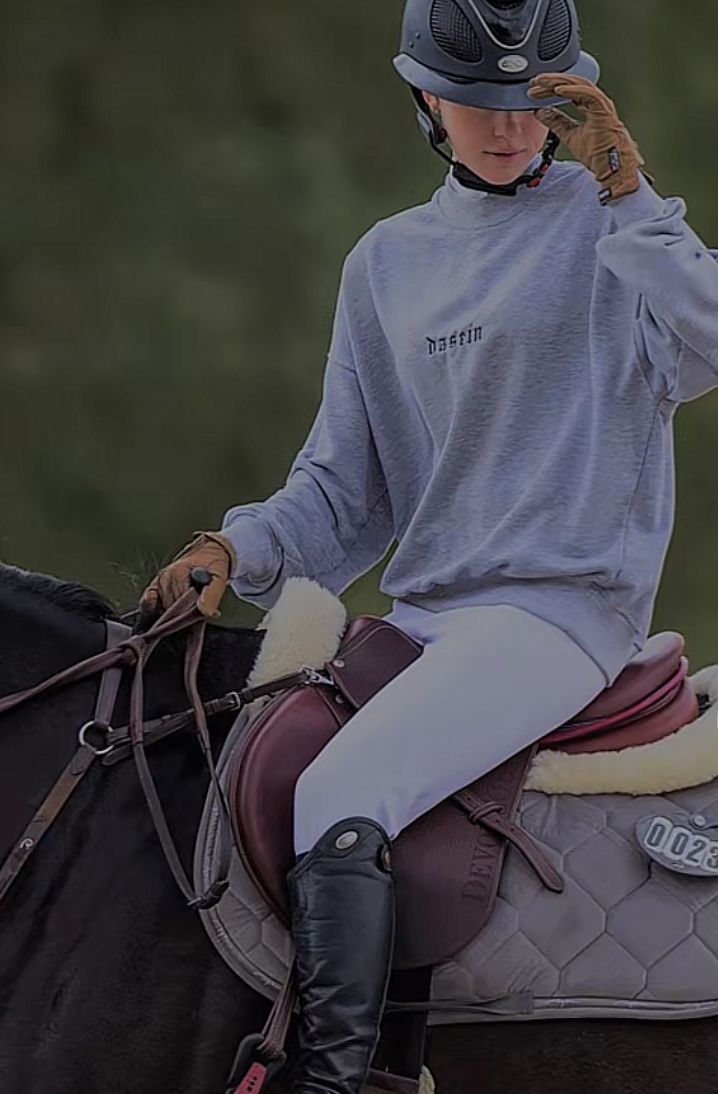 a woman riding on the back of a brown horse