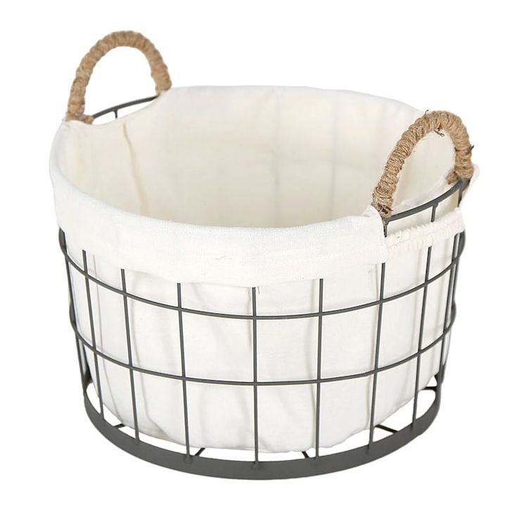 a wire basket with rope handles and a white fabric lining on the bottom, sitting in front of a white background