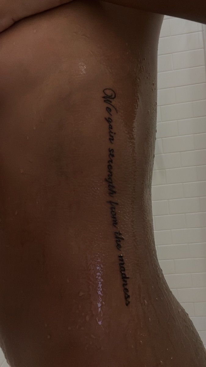 a woman's back with writing on it and the words written in cursive ink