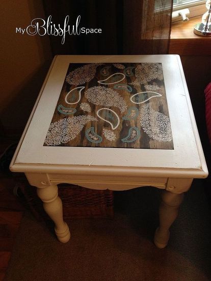 a white table with a painting on it