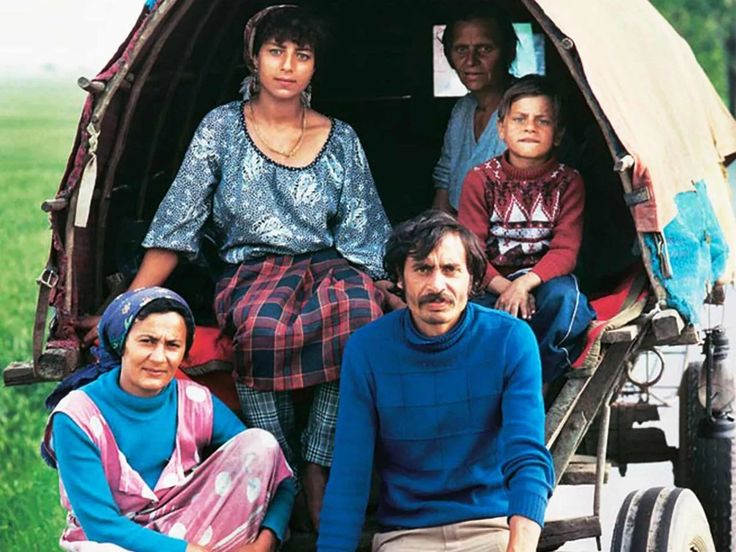 a group of people sitting in the back of a covered wagon