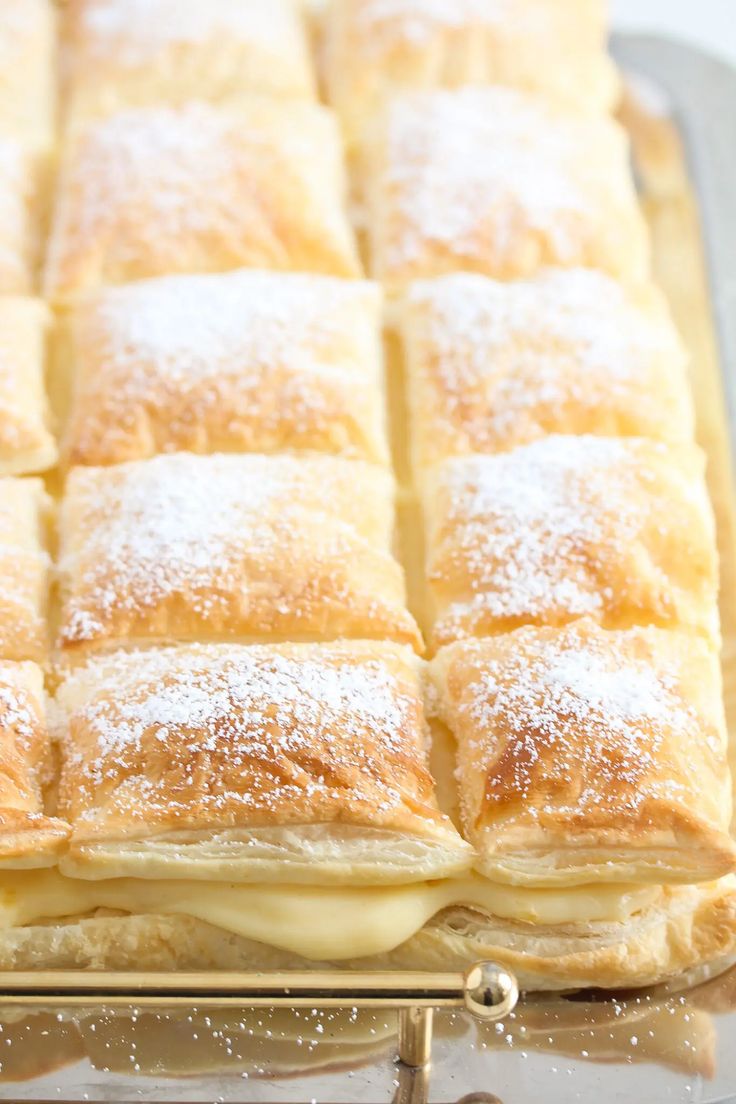 a pastry sitting on top of a pan covered in powdered sugar