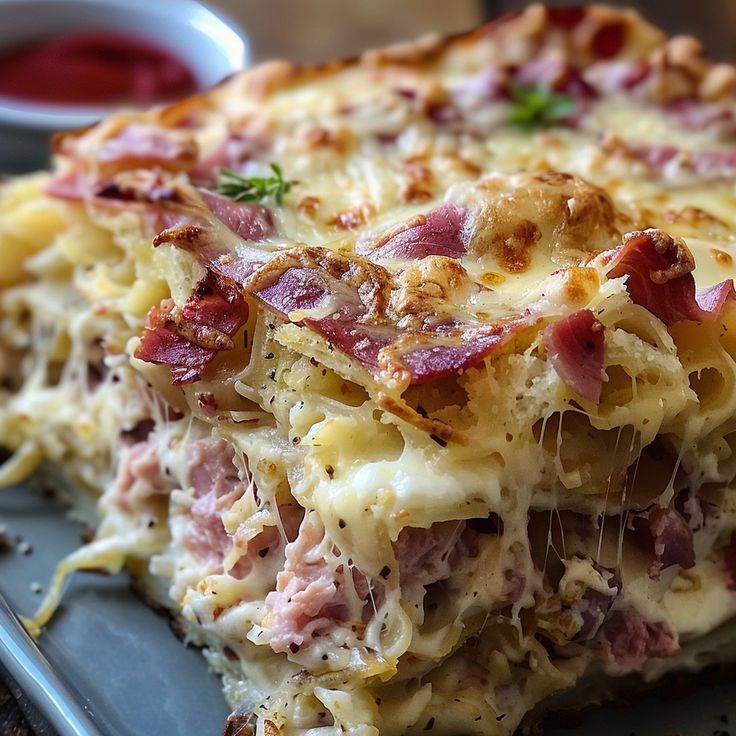 a close up of a plate of food with ham and cheese casserole on it