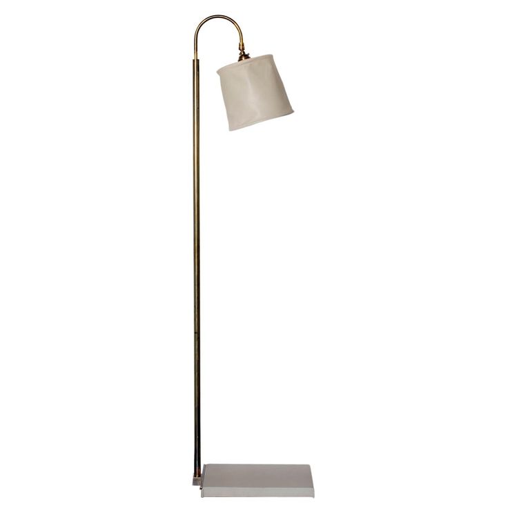 a floor lamp with a white shade on the base and a metal stand underneath it