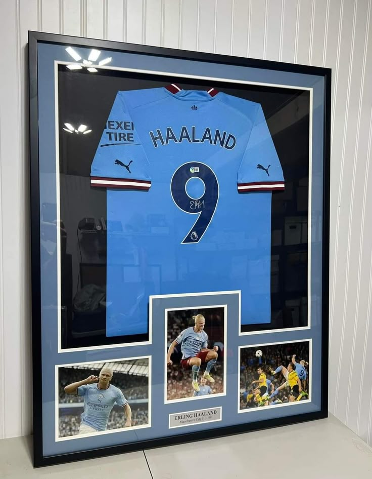 a soccer jersey is displayed in a black frame with photos and an inscription on it