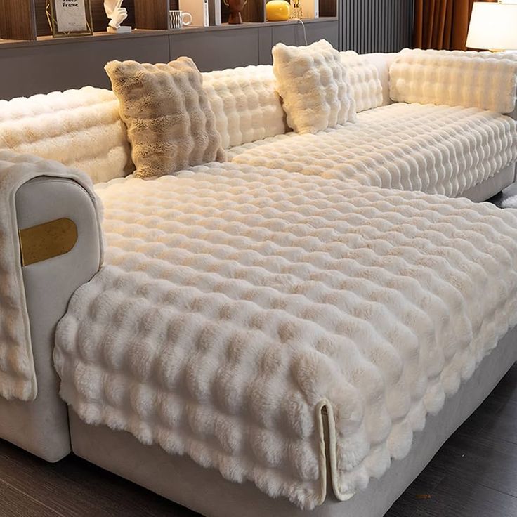 a large white couch sitting on top of a hard wood floor