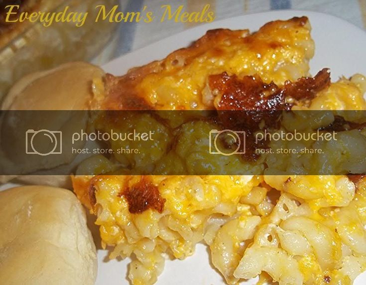 macaroni and cheese casserole on a white plate with bread buns