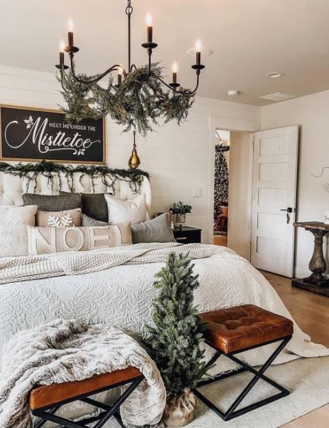 a bedroom decorated for christmas with candles on the headboard and lights hanging from the ceiling