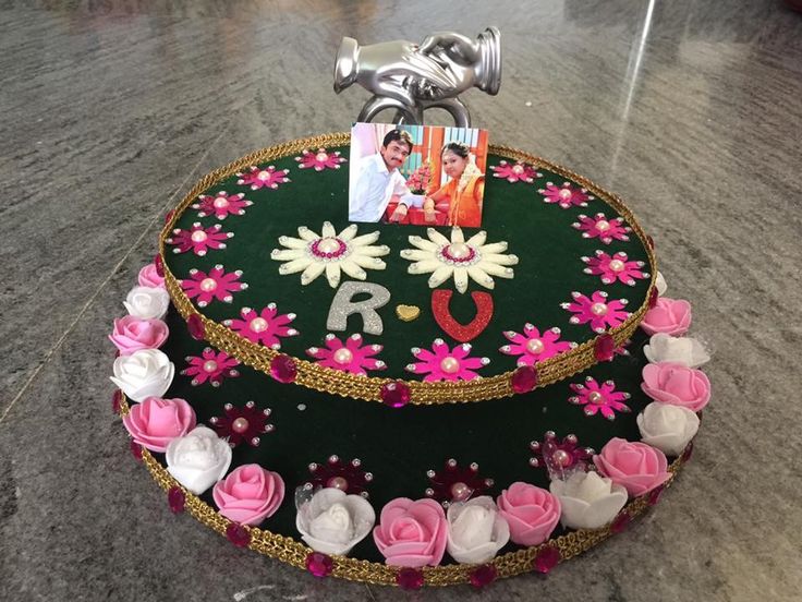 a cake decorated with flowers and photos on it