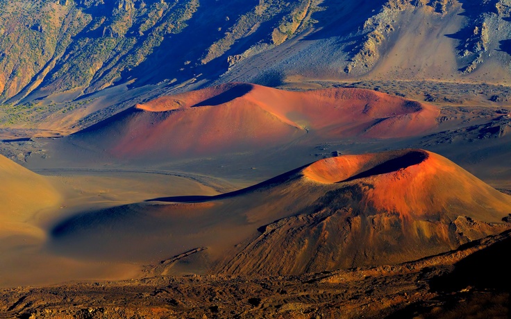 an aerial view of the desert with mountains in the background