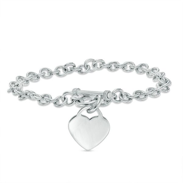 Simple, meaningful and so stylish, this darling heart charm bracelet is certain to win hers. Fashioned in sleek sterling silver, this rolo chain bracelet is finished with a lovely heart-shaped dangle charm. A look she'll treasure, this 7.25-inch bracelet is polished to a brilliant shine and secures with a toggle clasp. Zales Jewelry, Plus Size Fashionista, Cheap Silver Rings, Toggle Bracelet, Stacked Jewelry, Colorful Jewelry, Jewelry Lookbook, Girly Jewelry, Rolo Chain