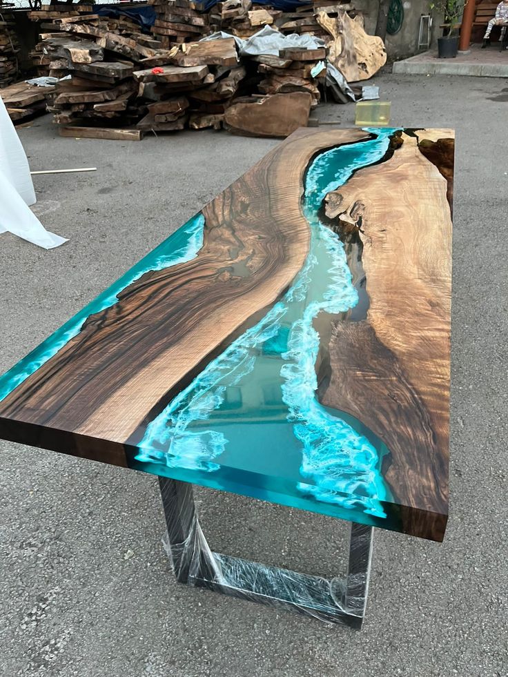 a table that is made out of wood and has blue water running down the side