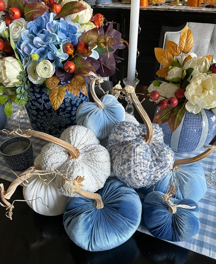 blue and white pumpkins sitting on top of a table