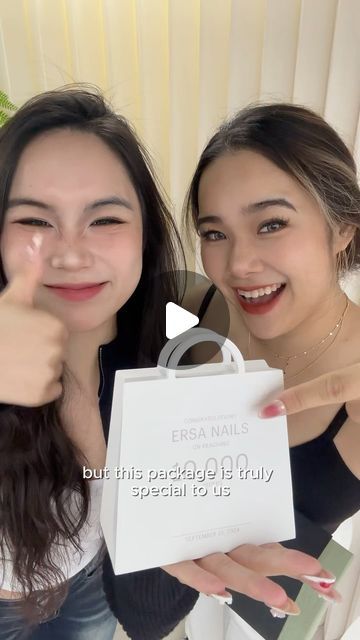 two young women giving thumbs up while holding a white bag with the words, but this package is truly special to us