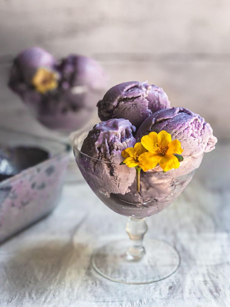 three scoops of purple ice cream with yellow flowers