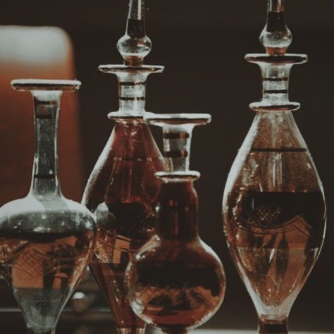 three glass vases sitting next to each other on a table