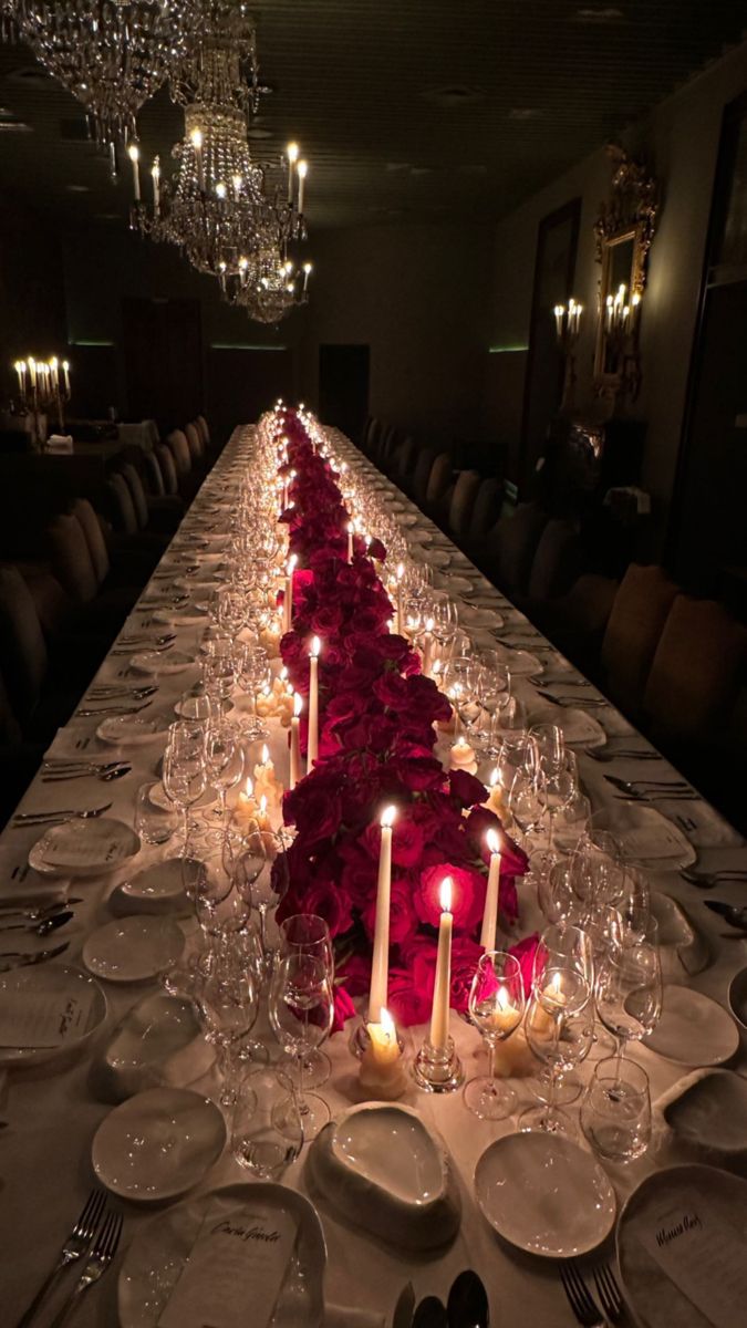 a long table is set with candles and plates for an elegant dinner party or special event