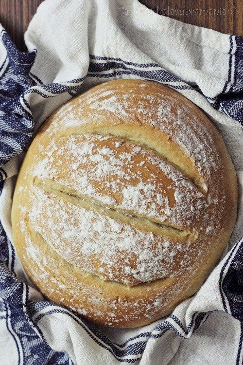 a loaf of bread sitting on top of a blue and white towel