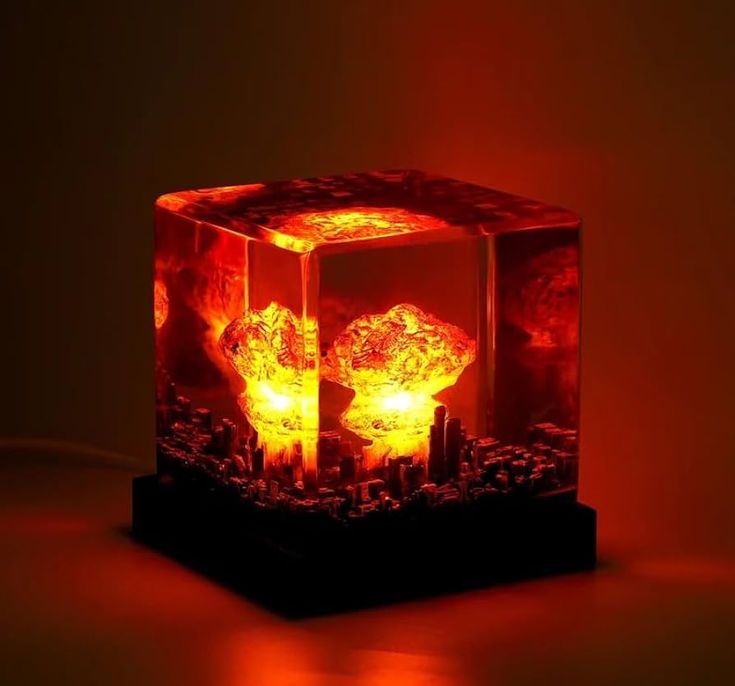 an illuminated cube shaped object on a table