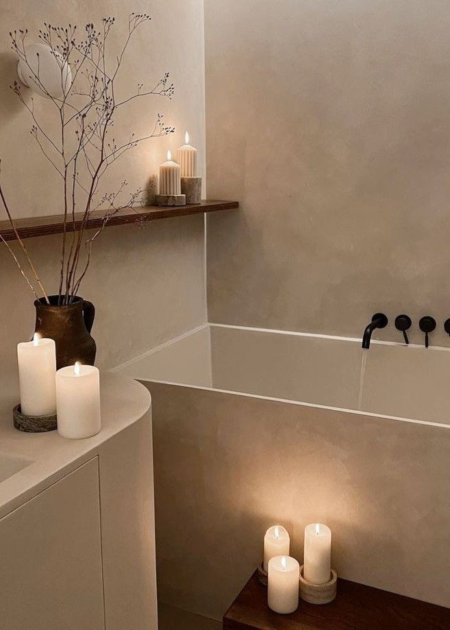 a bathroom with candles and a bathtub