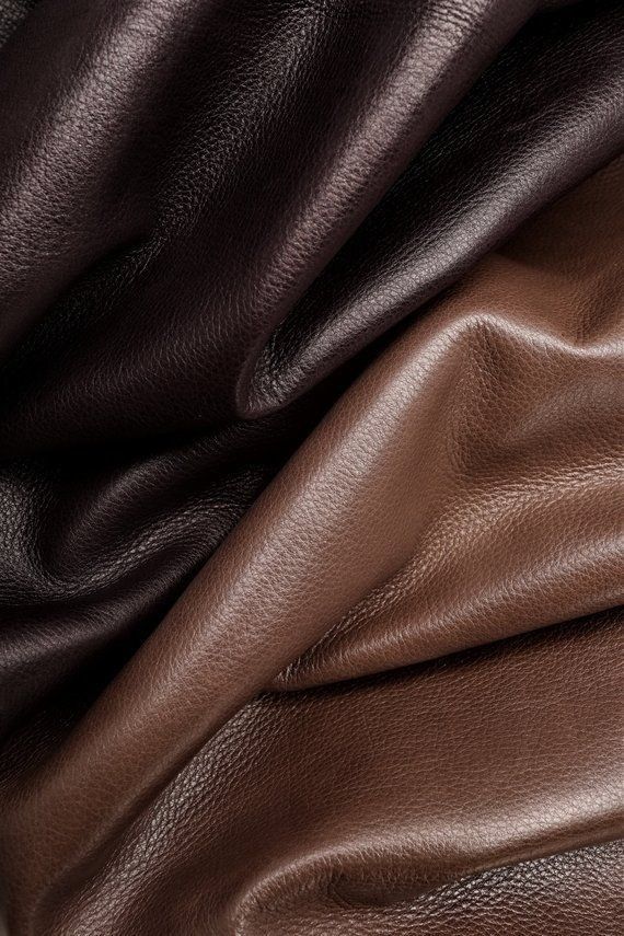 a brown leather textured up close to the camera, with other material in the background