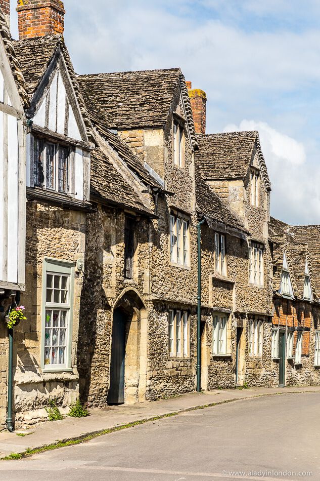 old stone buildings line the street in an english village