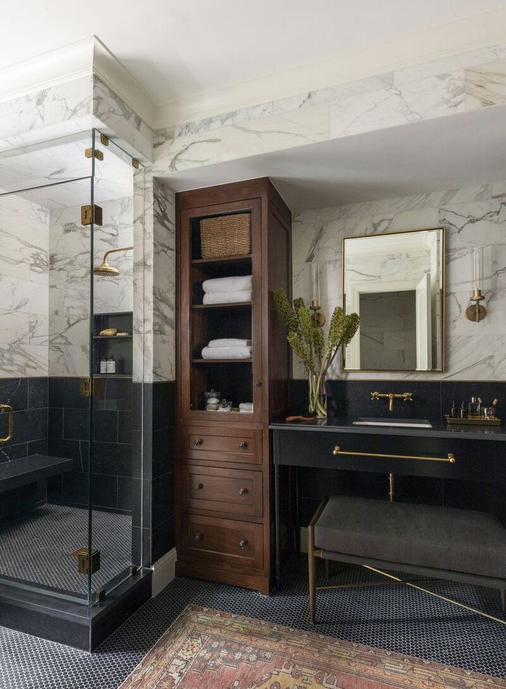 a black and white bathroom with marble walls