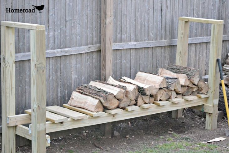 a pile of wood sitting on top of a wooden bench