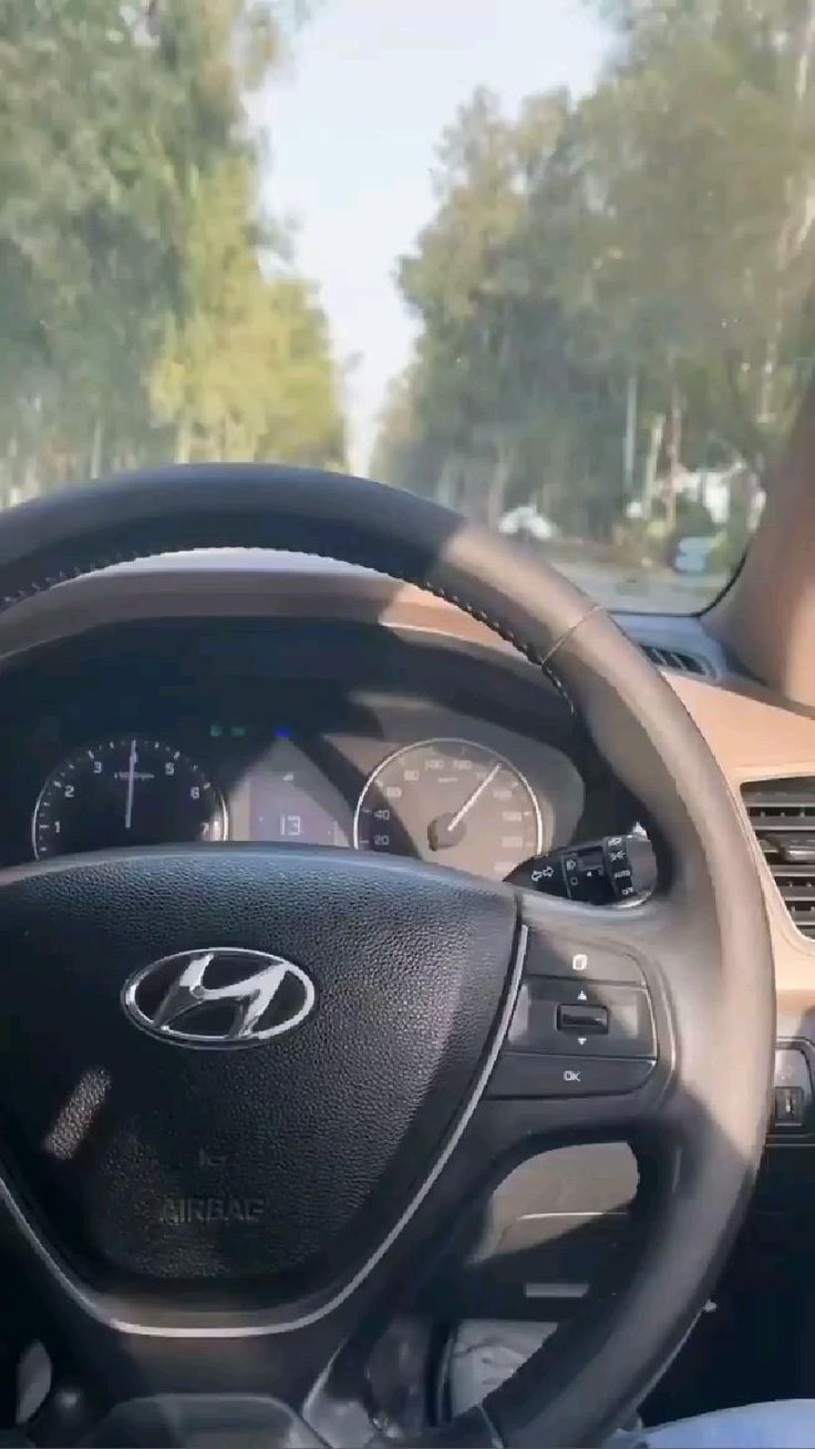 the interior of a car with steering wheel and dashboard