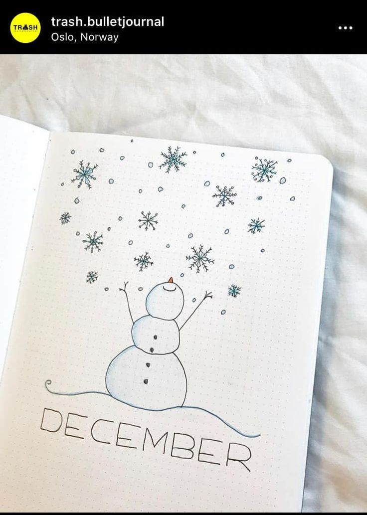 an open notebook with a drawing of a snowman and the words december on it