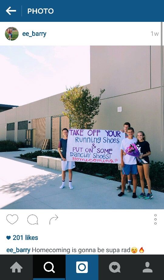 two young people holding a sign in front of a building that says take off your running shoes