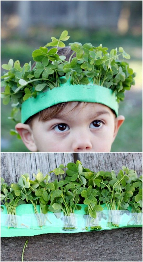 a young boy wearing a green headband with plants growing out of it