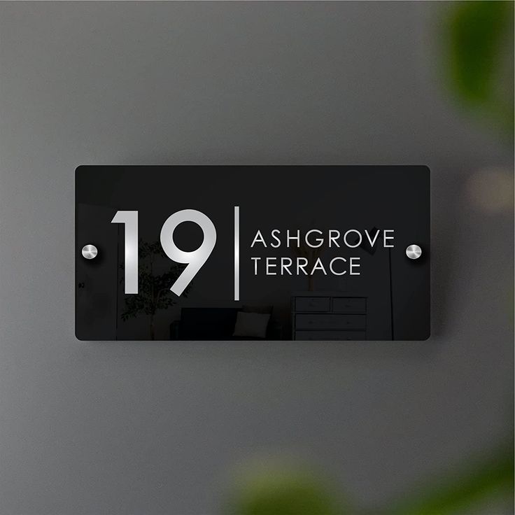 a black and white sign that reads 19 ash grove terrace on the side of a wall