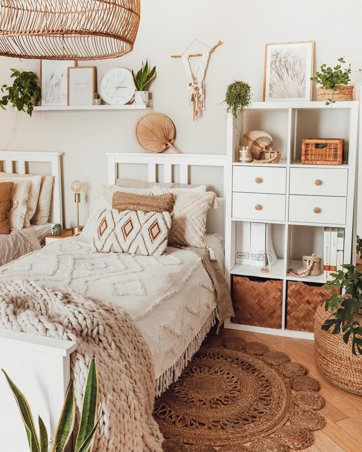 a bedroom with white walls, wooden floors and lots of plants on the shelves above the bed