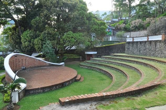 an outdoor stage with steps and grass