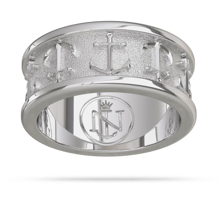 a white gold ring with an anchor and cross on the center, surrounded by diamonds