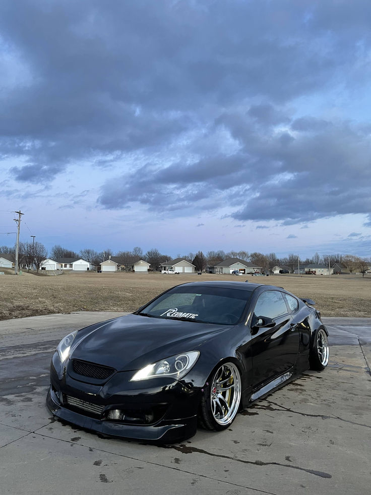 a black sports car parked in a parking lot