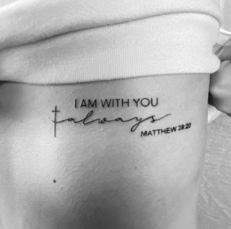 a woman's stomach with the words i am with you written in cursive font