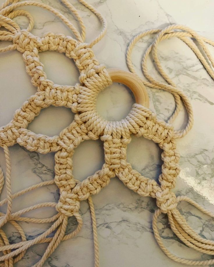 several pieces of crochet are arranged on a marble counter top, with circular holes in the middle