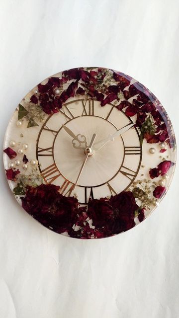 a clock that has flowers on it