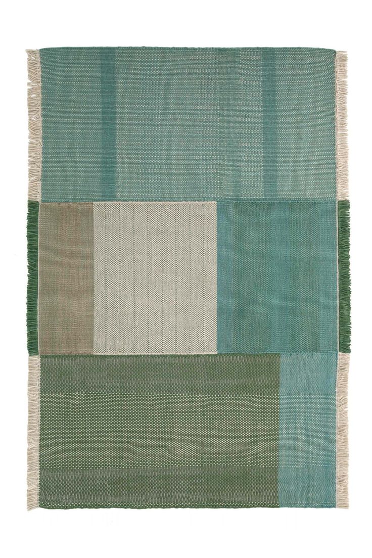 an area rug with different colors and patterns on the side, including green, white, blue