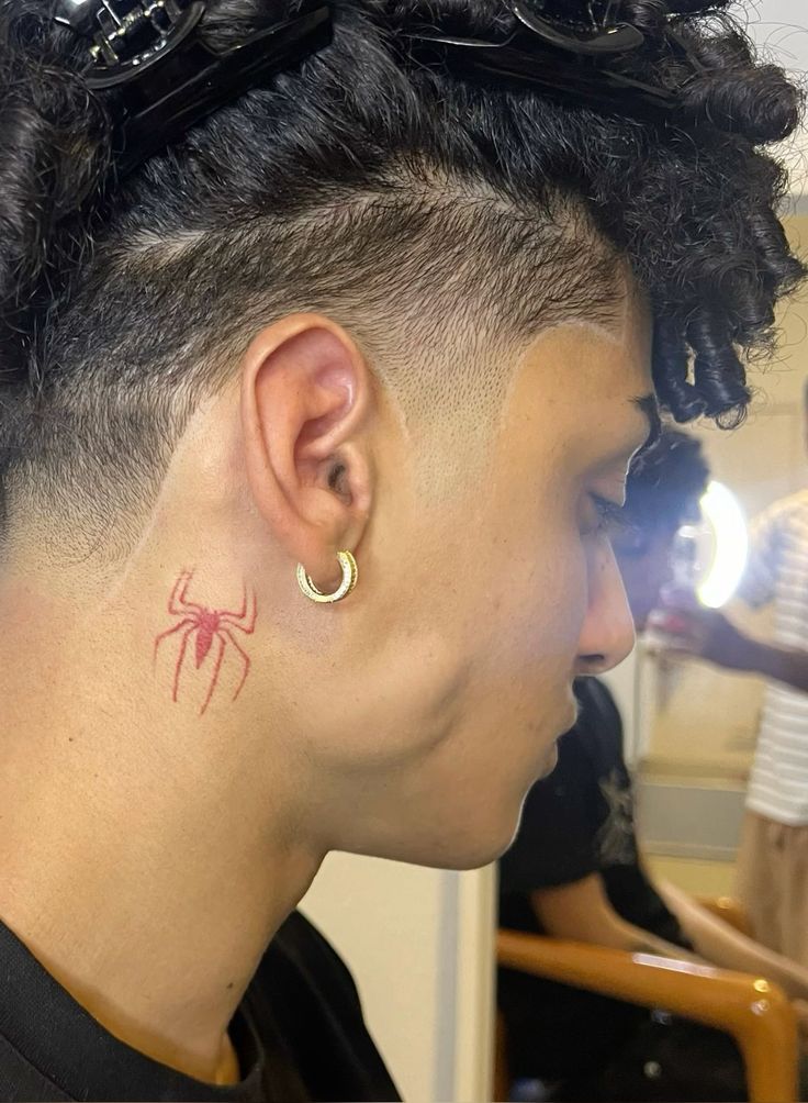 a woman with a spider tattoo on her left side of her neck and behind her ear