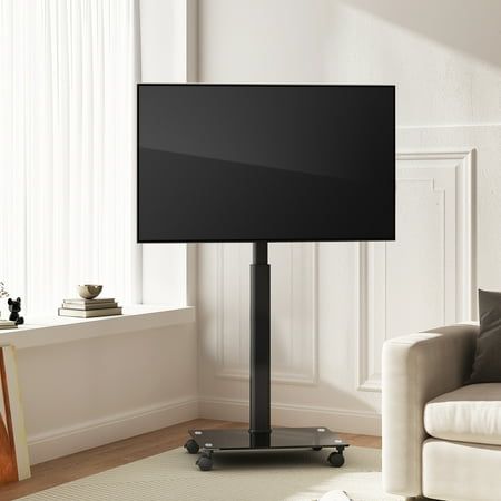 a flat screen tv sitting on top of a metal stand