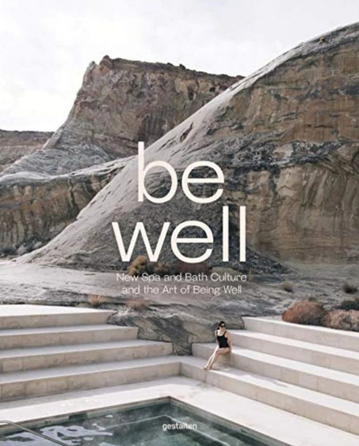 a woman sitting on steps next to a hot tub with the words be well above it