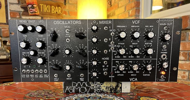 an array of knobs and controls on top of a table