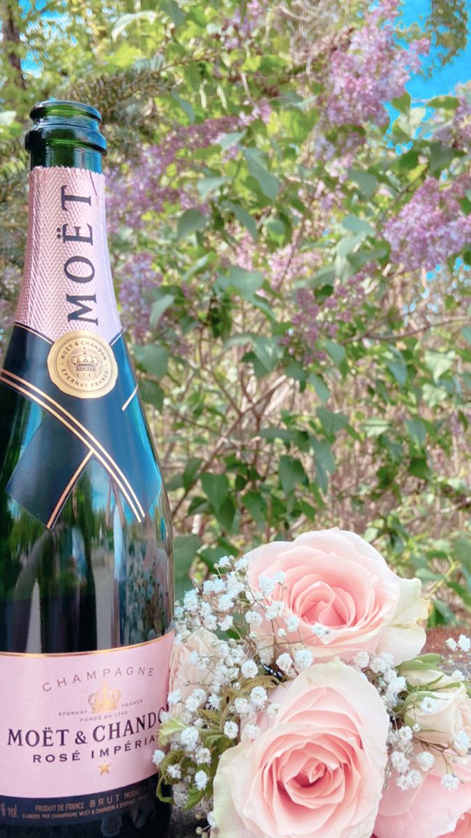 a bottle of champagne next to some flowers