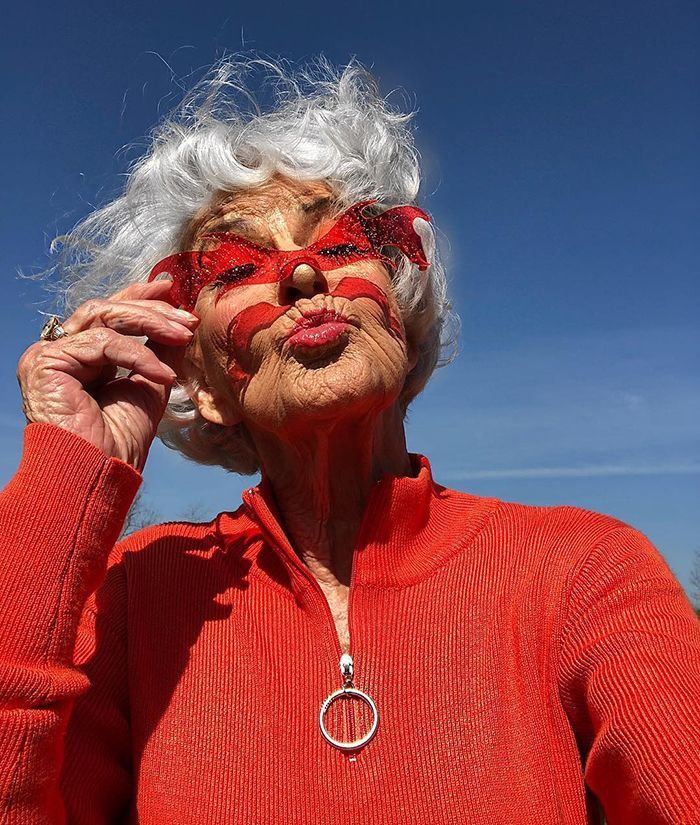 an older woman with white hair and red glasses