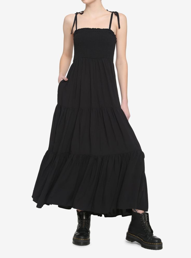 Keep your dark witchy vibes going strong in this black midi dress! Featuring smocked detailing around the bust and a tiered skirt. Comes with adjustable tie shoulder straps and side seam pockets. Pair with a black brimmed hat to complete your look! Girls Maxi Dresses, Brimmed Hat, All Black Looks, Goth Dress, Witchy Vibes, Tiered Midi Dress, Black Midi, Smocked Dress, Flowy Dress