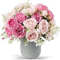 a vase filled with lots of pink flowers