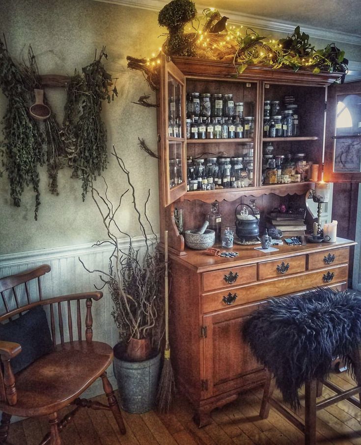 an old fashioned kitchen with herbs on the shelves